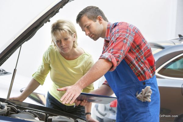 Auto mechanic and female customer in auto repair shop