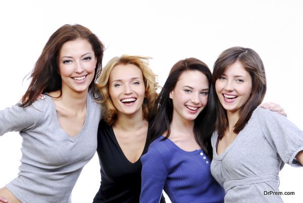 Group of four sexy, beautiful young happy women. Isolated on white