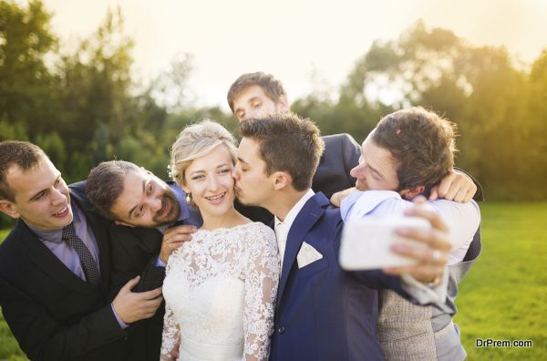 Bride with groom and his friends taking selfie