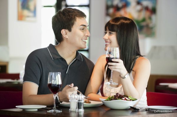 A young and attractive couple dining together in an indoor restaurant